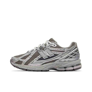 Lateral side view profile of dark grey and metallic silver New Balance running shoes