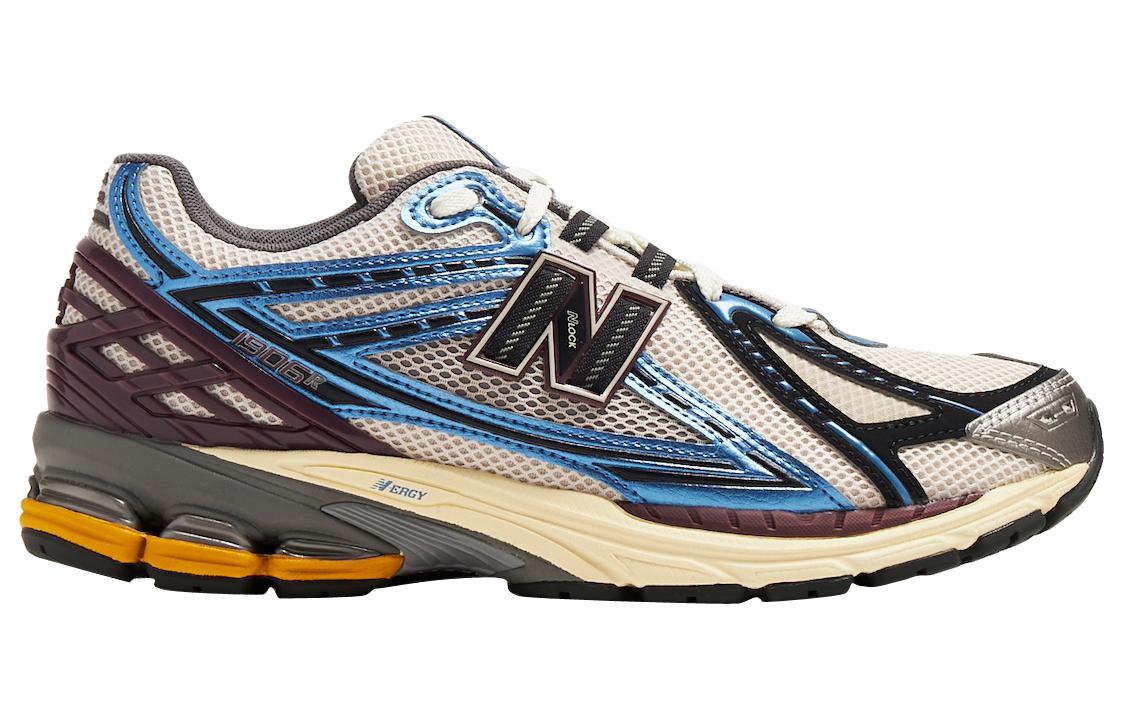 Medial side profile of white, blue, and purple New Balance shoes 1906R model, featuring a breathable white mesh base with metallic light blue and navy overlays, deep purple heel counter, N-lock side branding, white laces, and a cream and grey N-ergy cushioned sole with yellow heel pods.