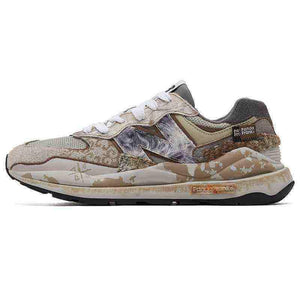 Lateral profile shot of custom distressed multi-patterned New Balance running shoes against a white background.