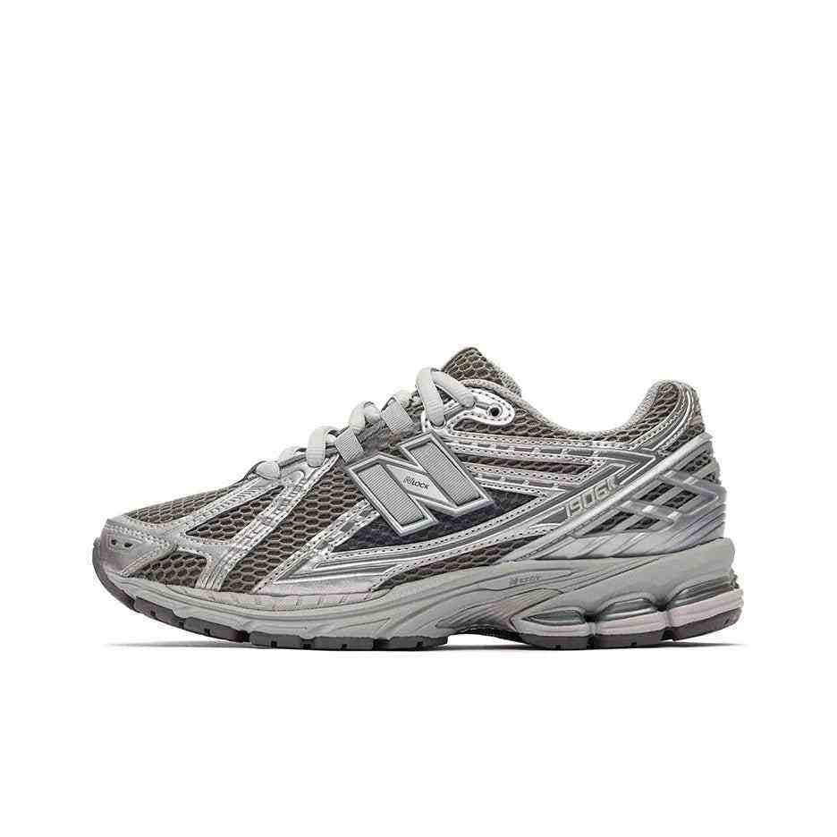 Lateral side view profile of dark grey and metallic silver New Balance running shoes