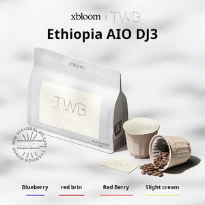 A white coffee bag with 'TWB' label next to individual XBloom xpods coffee capsules, featuring flavor notes for Blueberry, red brim, Red Berry, and Slight cream at the bottom.