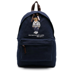 An authentic Ralph Lauren Polo Bear navy blue backpack with a brown leather top handle, leather zipper straps, and embroidered iconic bear, ideal for back-to-school and daily use.

حقيبة ظهر Ralph Lauren Polo Bear باللون الكحلي أصلية مع مقبض علوي وأشرطة سحاب من الجلد البني ودب مطرز شهير، مثالية للعودة للمدرسة والاستخدام اليومي
