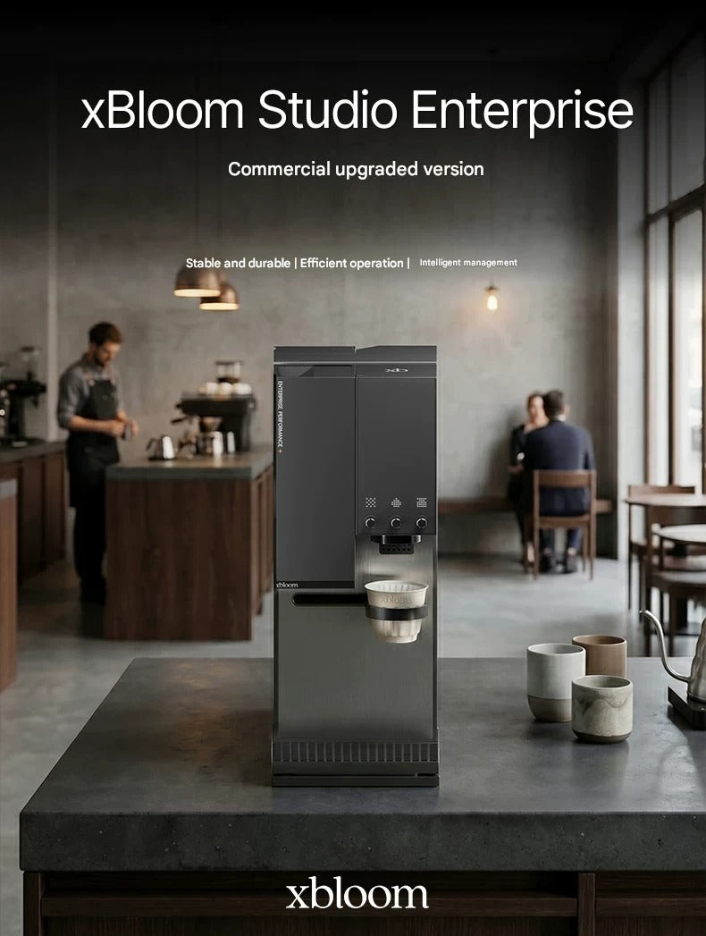 Matte black xBloom Studio Enterprise commercial automatic coffee machine placed on a dark countertop inside a modern specialty coffee shop.
اكس بلوم ستوديو
اكسبلوم ستوديو 